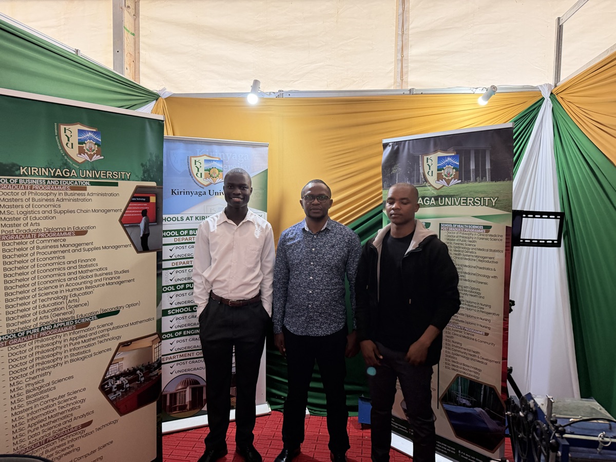 The TRACE team posed in front of Kirinyaga University banners at their booth